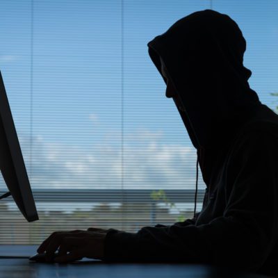 Person in hoodie working on computer
