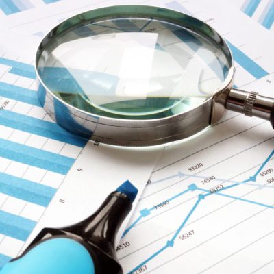 Magnifying glass and financial documents