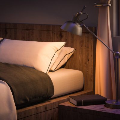 bedroom interior with book and reading lamp